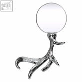 Silver magnifying glass shaped like stag antlers with a round clear glass lens for detailed viewing