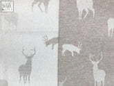 Gray and white deer patterned stag throw made from soft merino lambswool with a textured woven feel