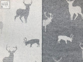 Gray and white deer-patterned stag merino lambswool throw with a textured woven finish in grey