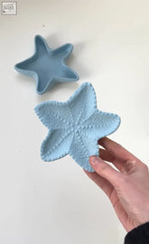 A light blue ceramic starfish trinket dish with a textured bumpy surface perfect for small items