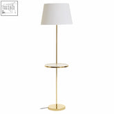 Stockholm shiny brass floor lamp with gold finish white conical shade and circular glass side table