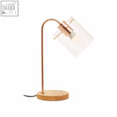 Copper curved table lamp with shiny copper finish, frosted glass shade, and wooden base for stylish desk lighting