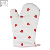 White single oven glove with red strawberry patterns and pink wrist strap in strawberry fields design