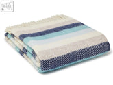 A folded stripe pure new wool throw in navy blue light teal and cream with herringbone pattern and fringed edges
