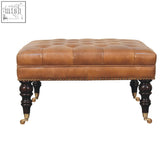 Brown tufted buffalo hide leather ottoman with brass accents and dark wooden castor legs storage bench
