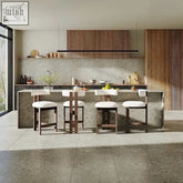 Modern minimalist kitchen island with textured concrete top and four white cushioned subi bar stools in wooden base