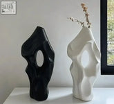 Black and white abstract ceramic tagushi vases with organic shapes and oval cutouts perfect for home decor
