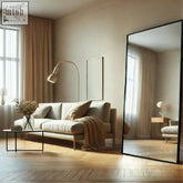 Beige upholstered sofa with wooden legs and throw blanket next to takara 180x105cm matte black steel frame mirror