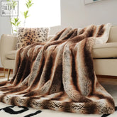 Takora throw plush faux fur blanket with natural beauty brown and cream striped earthy tones draped over beige sofa