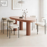 Modern tammy dining table with oval matte terracotta top and fluted cylindrical brown legs for stylish dining