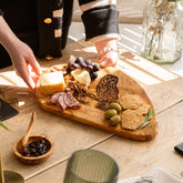 Light brown olive wood chopping board with a carved tawny owl design perfect for cheese and prep work