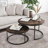 Set of two round teburu coffee tables with dark wood tops and black metal circular bases for living room use