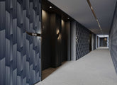 Tempest dark blue geometric wall panel with white vertical lines and black room number plaque 1518