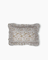 The Betsy floral frill cushion is a rectangular pillow with muted earth tone floral pattern and soft ruffled edges