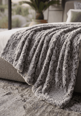 A cozy haku full-length throw blanket in textured gray with a soft fuzzy surface and ribbed pattern perfect for snuggling