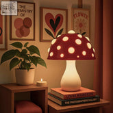 The manita lamp is a red ceramic mushroom lamp with white polka dots and a glowing interior inspired by amanita mushroom plug types