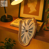 Golden melting clock with black roman numerals and white face functional art measuring 18x12x5 inches