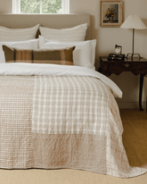 Beige and cream patchwork house throw with plaid pattern and textured fabric sections for cozy decor