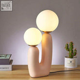 Pastel pink ceramic pink cacti lamp with two glowing spherical shades perfect for cozy lighting