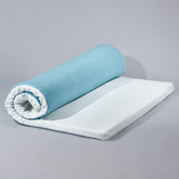 Light blue and white rolled memory foam mattress topper with textured surface for The Prestige Bamboo Mattress Topper