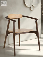 A minimalist scandi slim arm chair with dark brown wooden frame and light natural wood seat and backrest