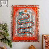 Vibrant orange serpent woven tapestry featuring a coiled teal snake with celestial motifs and fringe edges