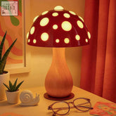 A shiitake lamp with a red polka dot mushroom shade and wooden grain base perfect for cozy lighting