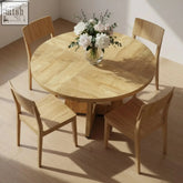 The somerset round oak pedestal dining table with light wood finish and four matching minimalist chairs