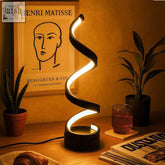 Black spiral table lamp with sleek modern design and warm ambient lighting perfect for cozy spaces