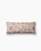 The thistle and bloom lumbar cushion is a rectangular soft blush pink fabric cushion with elegant floral beige and gray patterns