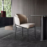 Beige upholstered theobald dining chair with sleek black metal frame and gold-toned accents for stylish dining