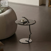 Modern black glass side table theobald face with a twisted carbon steel rack base and tempered glass top