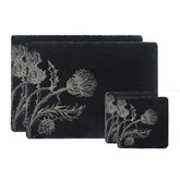 Set of black slate place mats and coasters with engraved silver thistle design in thistle trio slate set