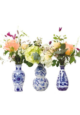 Three delft bud vases in elegant blue and white porcelain with detailed floral patterns perfect for decor