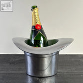 Silver solid cast top hat wine cooler holding green moët & chandon bottle as a stylish hat wine cooler