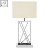Trajectory table lamp with a chrome stainless steel body, geometric base, and cream fabric shade for stylish lighting