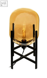 Trieste matte black and glass table lamp with amber glass globe and black metal stand featuring exposed filament bulb