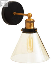 Trieste matte black wall light with a black wall base, brass arm, and clear glass shade with exposed filament bulb