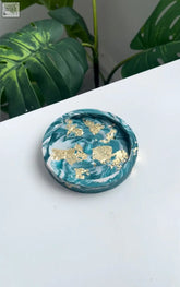 Trinket dish teal marble made of teal and white marbled resin with scattered gold leaf accents for small items