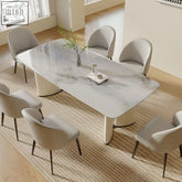 Modern white marble trish dining table with sleek curved cream legs and a minimalist design perfect for dining spaces