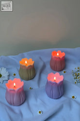 Pastel-colored tulip shaped candles with soft glowing flames perfect for cozy home decor and gifts