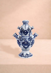 Tulipiere pyramid vase is a white ceramic with blue floral geometric patterns and multiple spouts in a tiered design