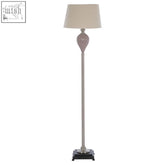 Ulalia floor lamp with slender metallic pole and fluted ceramic pink glass base under soft beige shade