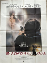 Black and white movie poster for assassin qui passe featuring jean-louis trintignant carole laure and richard berry