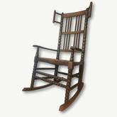 Dark brown wooden bobbin rocking chair with spindle back and legs perfect for cozy bobbin rocking sessions