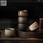 Stacked ceramic tea cups from usagi glass with earthy tones and textured glazes in muted browns and grays