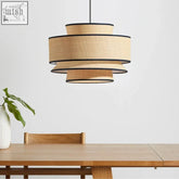 Beige woven lampshade with black trim and tiered design made of natural rattan for a cozy utsu light look
