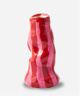 A glossy ceramic Valentine’s Candy Stripe Vase shaped like bacon with bold red and pink stripes