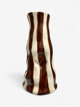 A ceramic vanilla gelato vase with a wavy shape and vertical brown and cream striped glaze