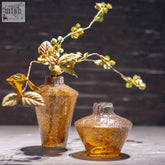 Two amber textured mouth blown glass vases from the dutz collection with a rustic hand blown look